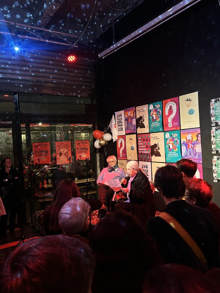 Josy holding the microphone alongside her colleague, a member of the MLAC.